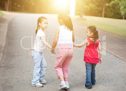 Asian children walking outdoor.