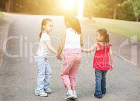 Asian children walking outdoor.