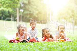 Asian children picnics outdoor.
