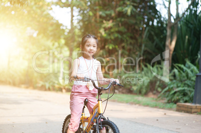 Child riding bike outdoor.