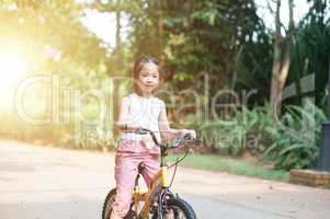 Child riding bike outdoor.