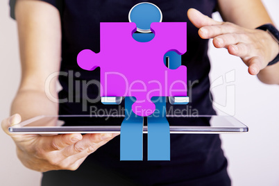 Person with tablet pc and puzzle pieces