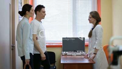 Couple visiting female ophthalmologist in clinic