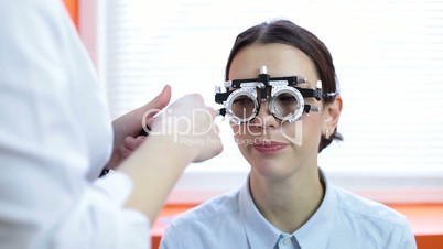 Cute woman with trial frame for lens determination