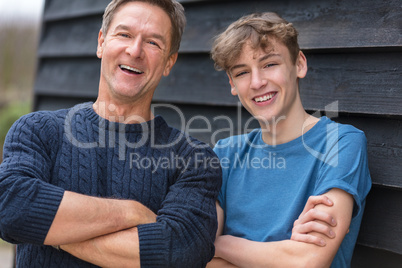 Happy Middle Aged Man Father and Teenage Son Arms Folded