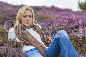 Young Woman Girl in Field of Purple Heather Flowers