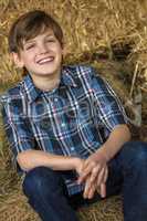 Young Happy Boy Smiling on Hay Bales