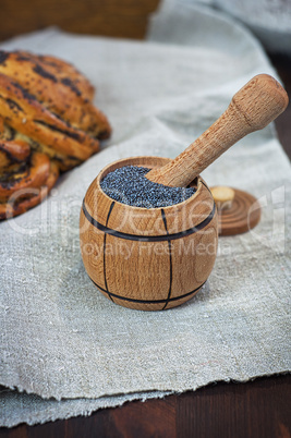 poppy seed in wooden containers on a brown table