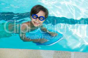 Smiling boy swimming in the pool