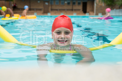 Smiling girl swimming in the pool