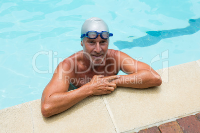 Smiling senior man standing in swimming pool