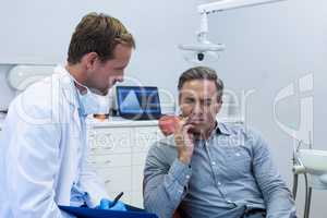 Dentist examining a male patient