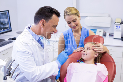 Dentist interacting with young patient