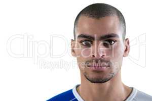 Portrait of football player standing against white background