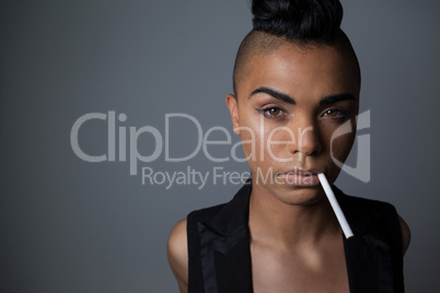 Portrait of transgender woman with cigarette in mouth