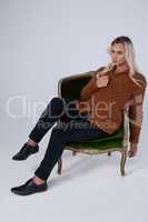 Transgender woman looking away while sitting on chair
