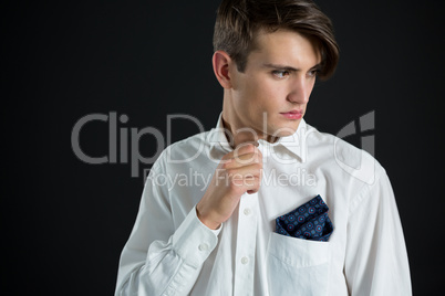 Androgynous man posing against black background