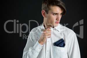 Androgynous man posing against black background