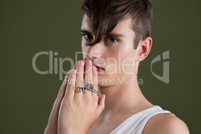 Androgynous man posing with palms together
