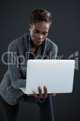 Androgynous man using laptop