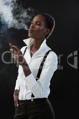 Androgynous man smoking a cigar