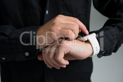 Androgynous man using smart watch