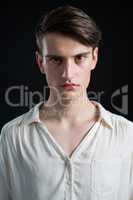 Androgynous man posing against grey background