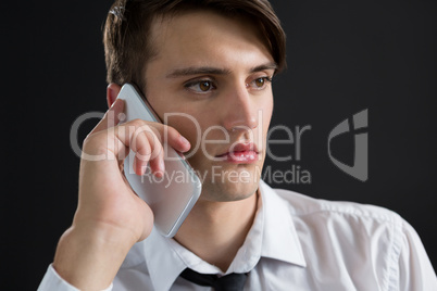 Androgynous man talking on his mobile phone