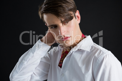 Androgynous man in muffler posing