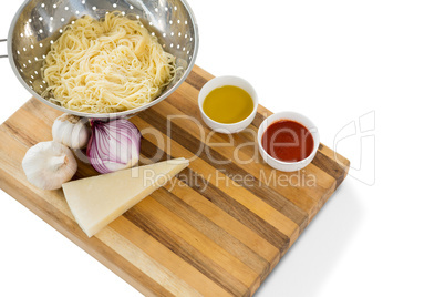 High angle view of pasta in colander with ingredients