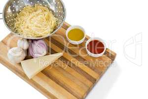 High angle view of pasta in colander with ingredients