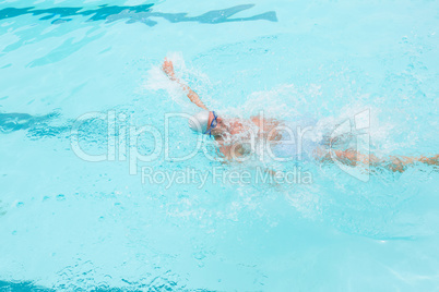 Senior man swimming in pool