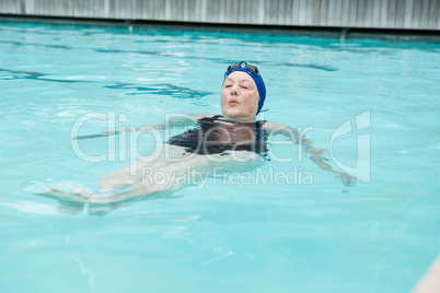 Senior woman swimming in pool