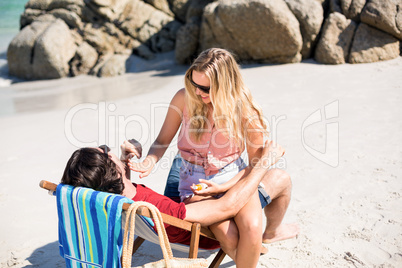 Romantic couple on deck chair at beach