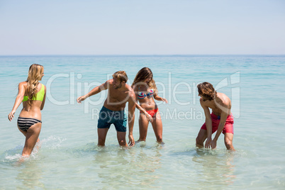 Cheerful young couples enjoying in sea