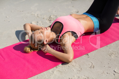 High angle view of young woman exercising on exercise mat
