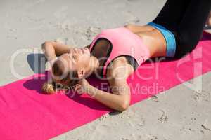 High angle view of young woman exercising on exercise mat