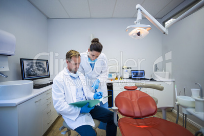 Dentists discussing on medical report in clinic