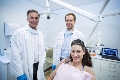 Portrait of smiling dentists and female patient