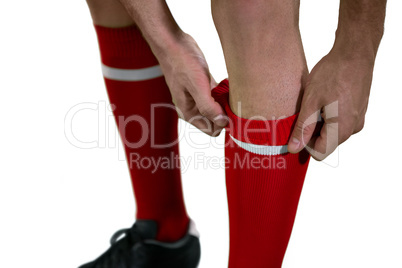 Football player pulling his socks up