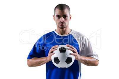 Portrait of football player holding football with both hands