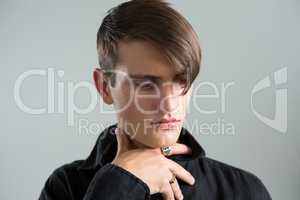 Androgynous man posing against grey background