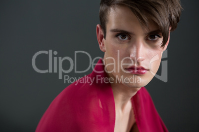 Androgynous man wrapped in red clothes