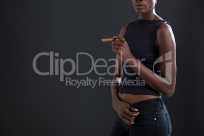 Androgynous man holding a cigar