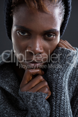 Androgynous man posing with hand on his chin