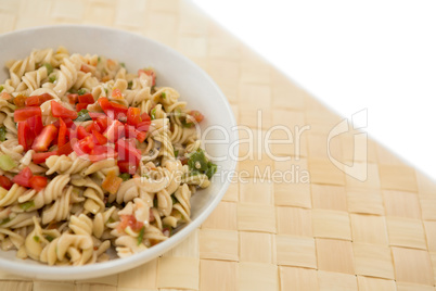 Close up of rotini served in bowl on place mat