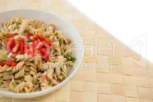 Close up of rotini served in bowl on place mat