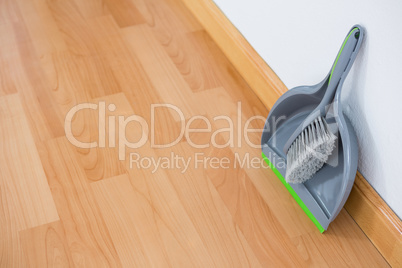 High angle view of dustpan and brush against wall