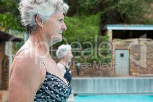 Senior women standing at poolside