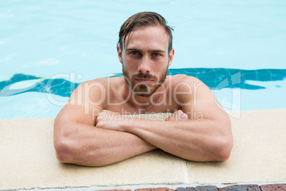 Lifeguard leaning on poolside